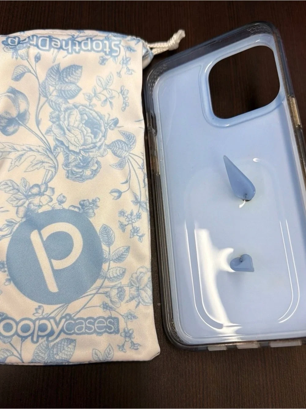Lightly Used Loopy IPhone 15 Promax case in blue toile.